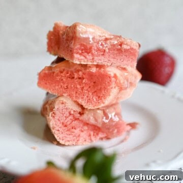 stack of strawberry brownies on a plate.