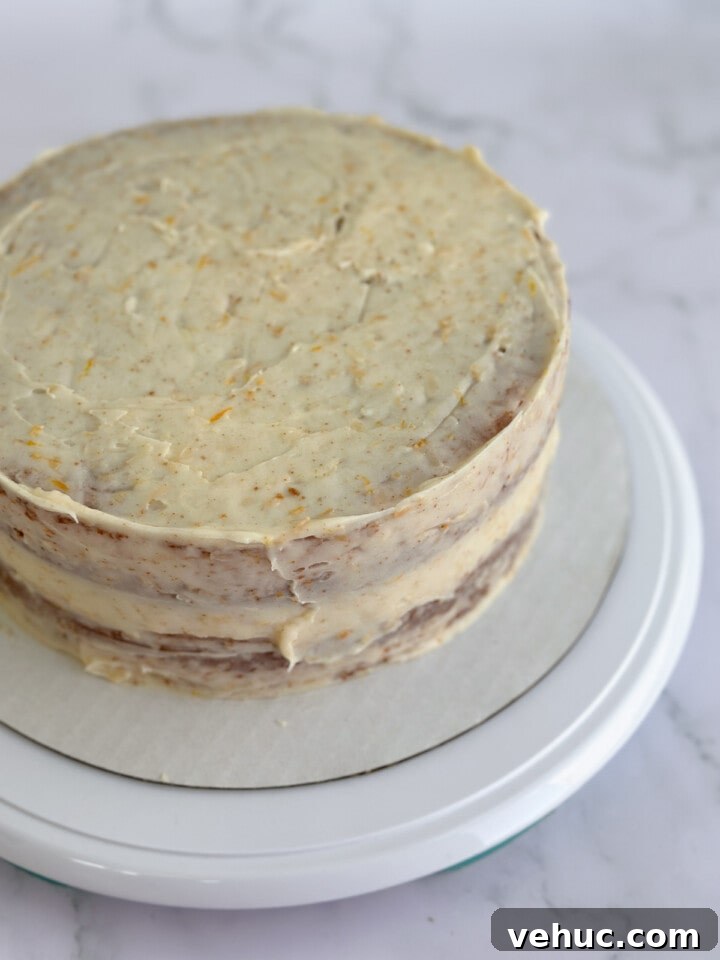 Moist Orange Coconut Cake Recipe with Zesty Glaze 15 a crumb coat on the whole cake.