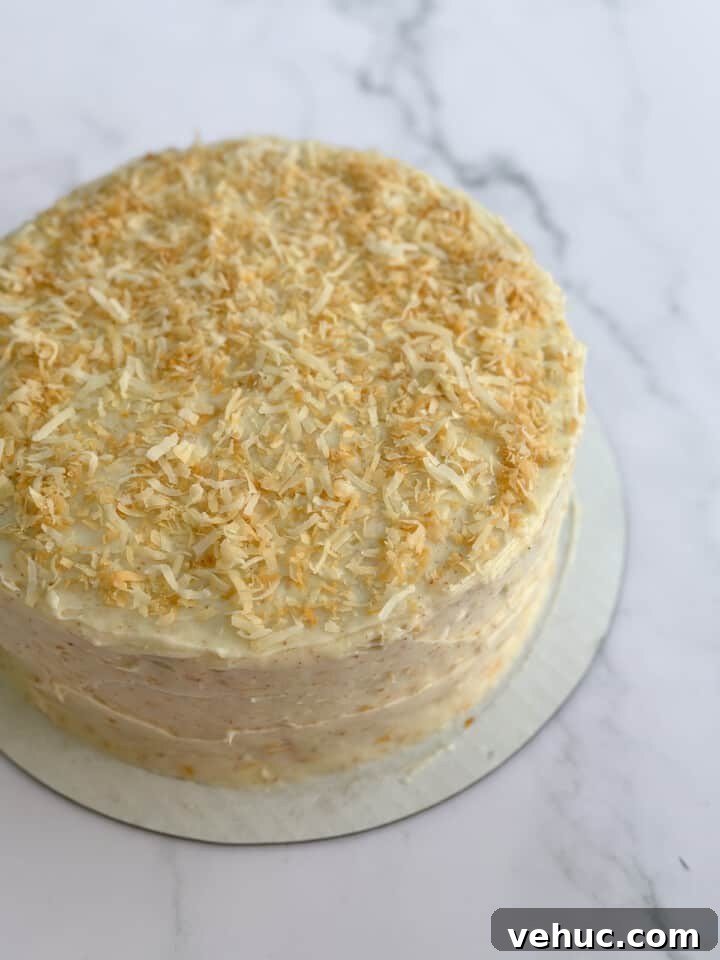 Moist Orange Coconut Cake Recipe with Zesty Glaze 16 the orange coconut cake with all the frosting and the coconut on top.