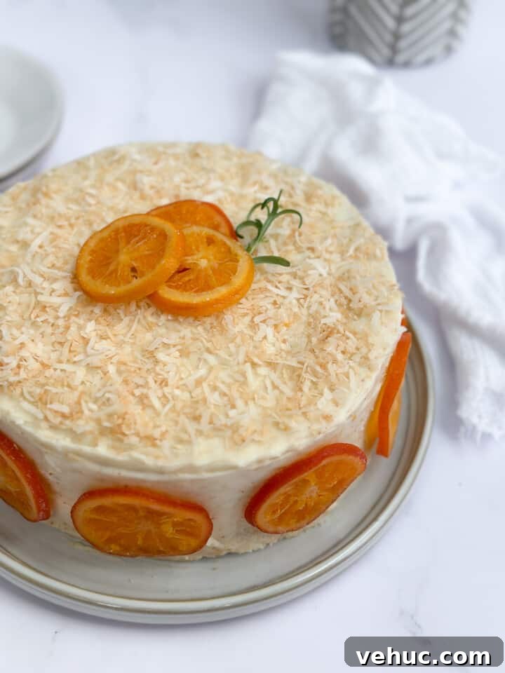 Moist Orange Coconut Cake Recipe with Zesty Glaze 17 an angled view of the orange coconut cake so you can see the top and the sides.