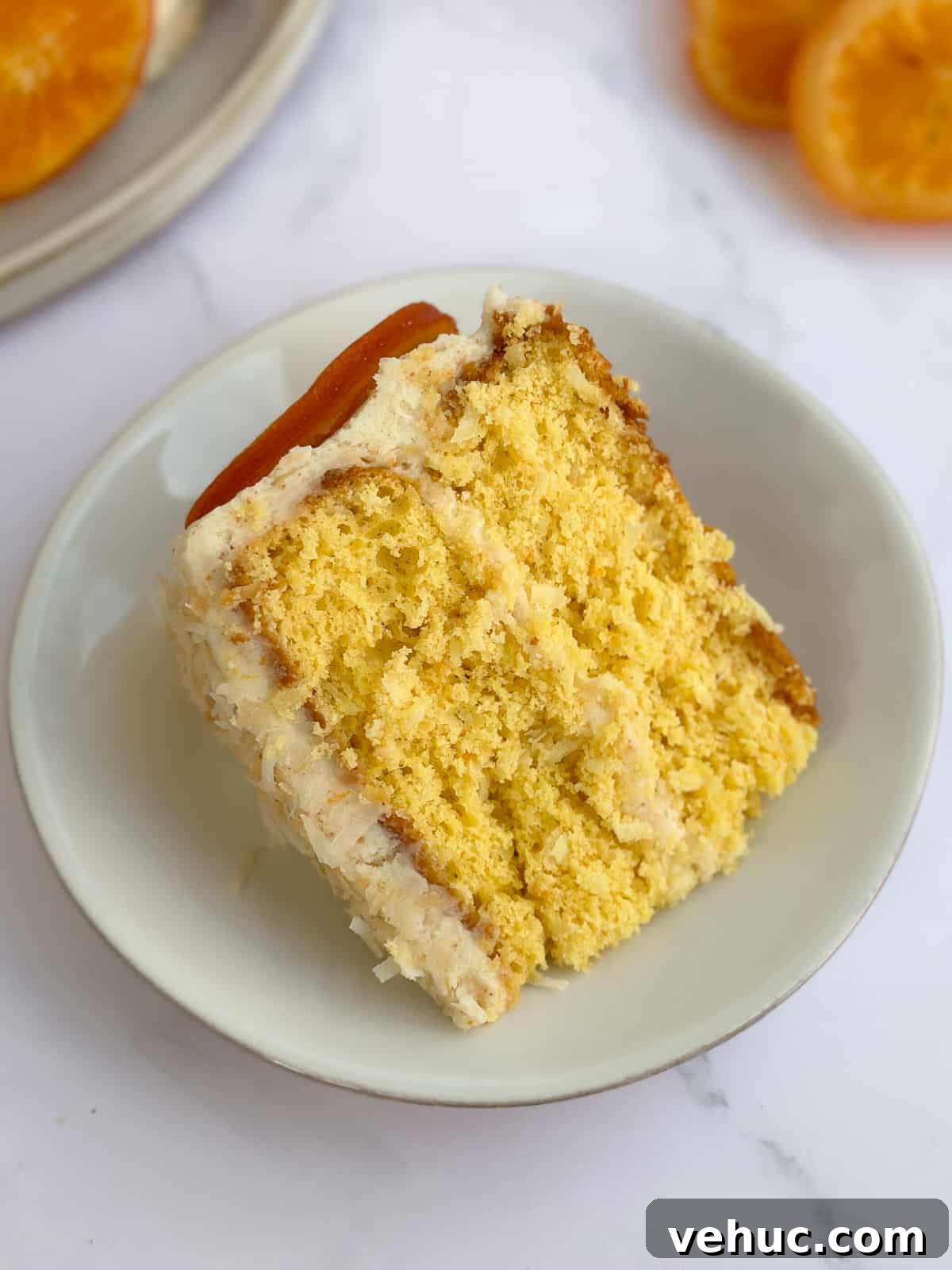 Moist Orange Coconut Cake Recipe with Zesty Glaze 19 a whole slice of orange coconut cake on a plate.