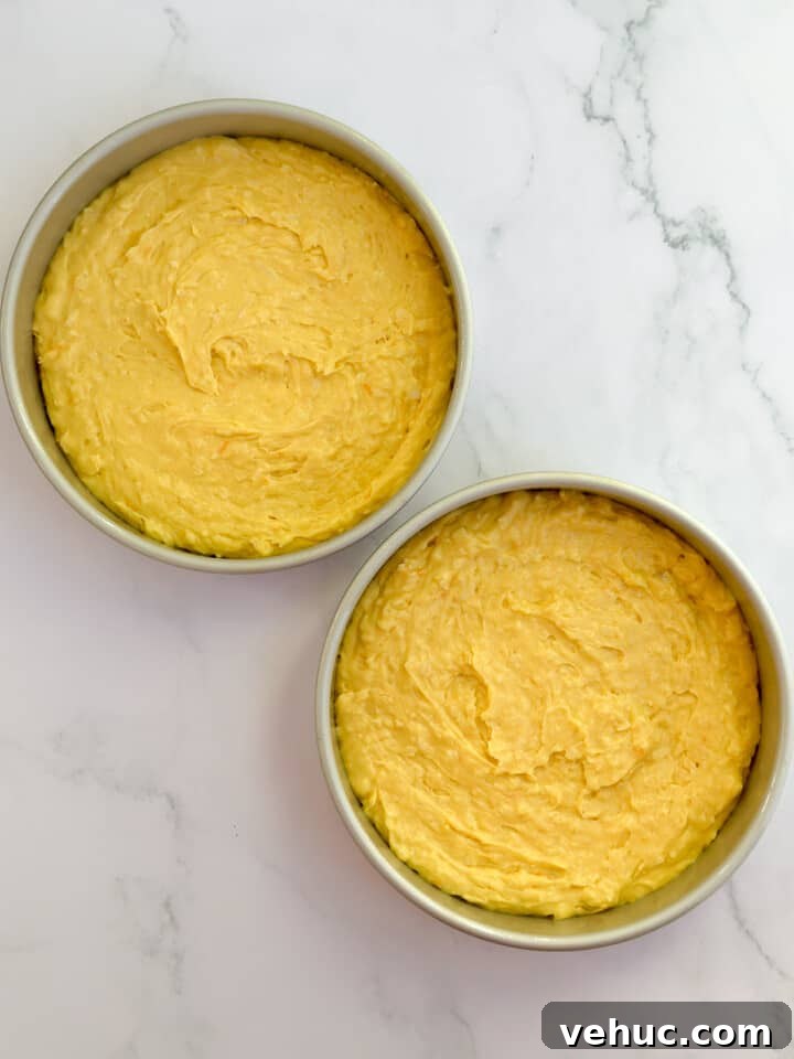 Moist Orange Coconut Cake Recipe with Zesty Glaze 7 cake in the pans before baking.