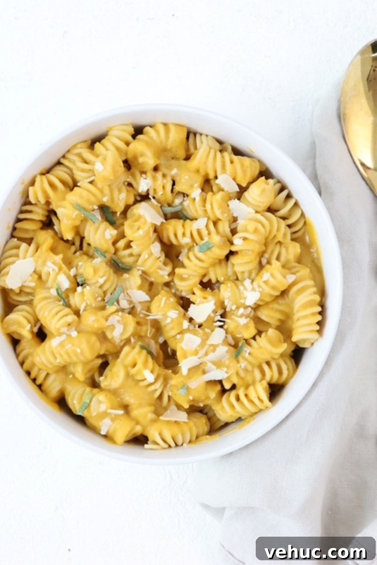 Creamy Roasted Butternut Squash Pasta Sauce Recipe 2 Pasta with butternut squash sauce in a white bowl topped with parmesan cheese and fresh sage.