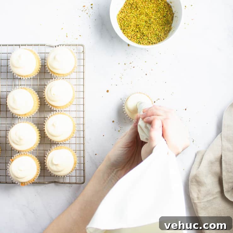 Persian Love Cake Cupcakes: Saffron Rose Water Dessert Recipe 4 overhead photo of cupcakes being frosted