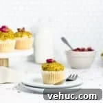 Persian Love Cake Cupcakes: Saffron Rose Water Dessert Recipe 7 cupcake on a plate with a bowl of rose buds and a jug of milk in the background